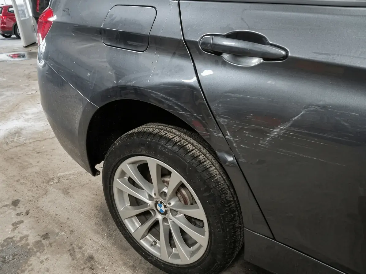 BMW with side-swipe damage being assessed on the Kairos Auto Center shop floor
